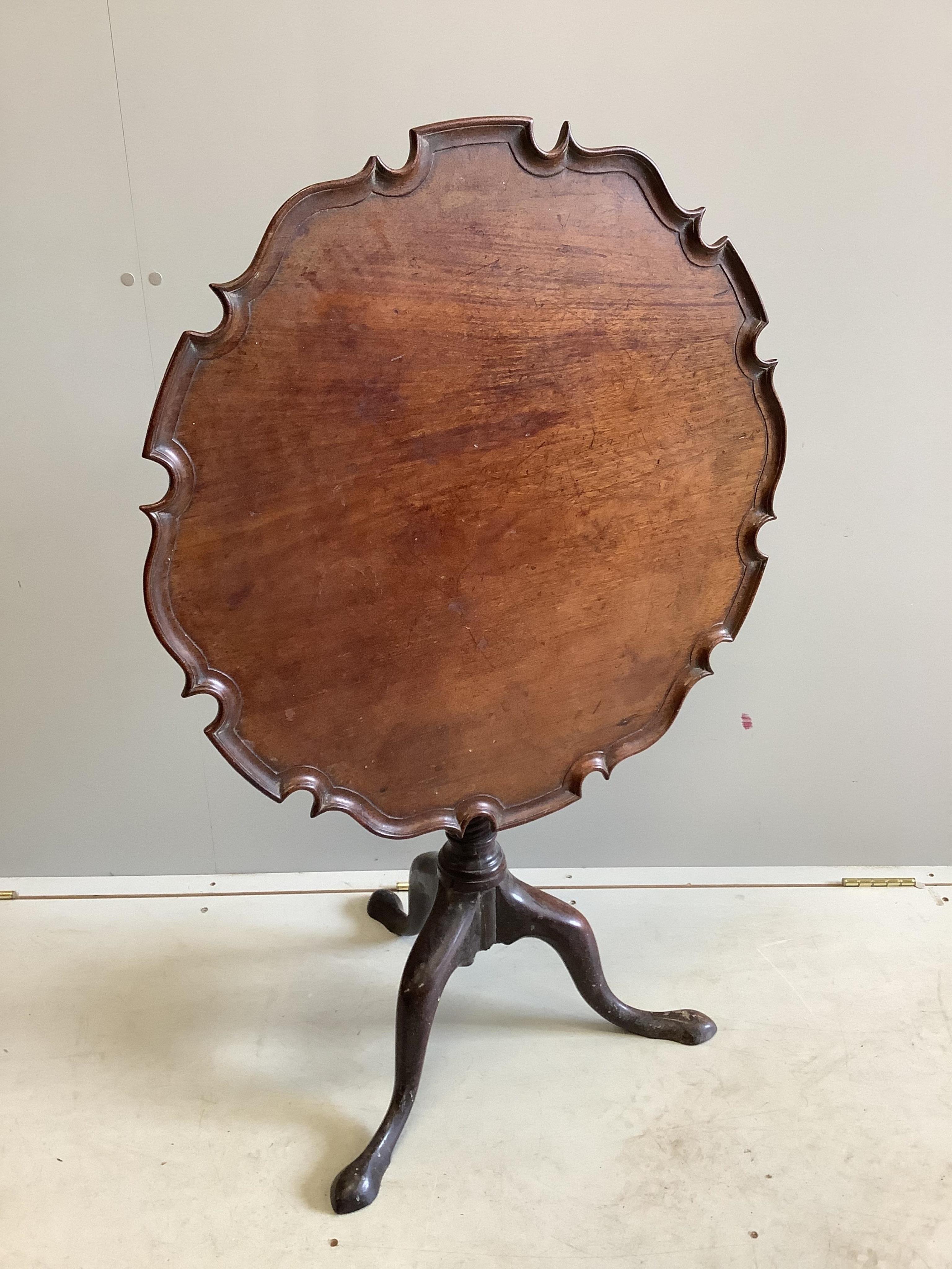 A George III circular mahogany tilt top tea table, diameter 70cm, height 68cm. Condition - fair